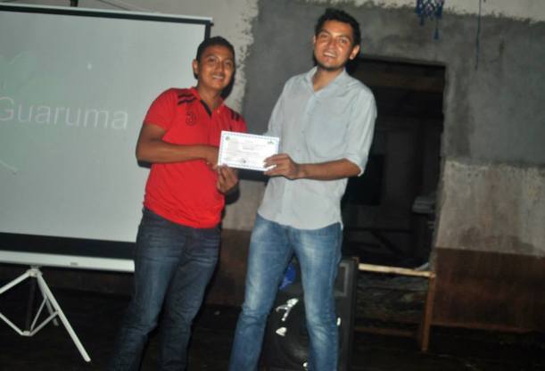 Marcos receiving his certificate of successful completion of the workshop.